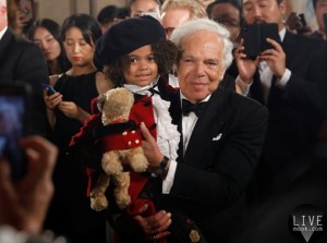 Designer Ralph Lauren holds a child model after his 50th anniversary fashion event during New York Fashion Week in New York